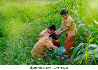 Little Boy Helping Another Boy By Pulling Hand Up