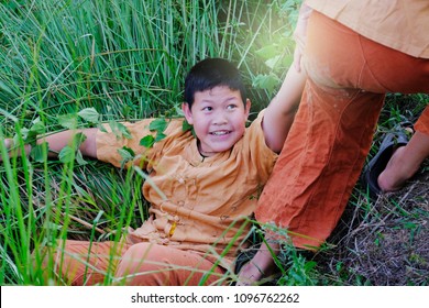 Little Boy Helping Another Boy By Pulling Hand Up