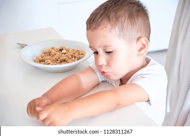 Little Boy Helps Dad Pour Milk Into Oatmeal. Quick Breakfast At Home