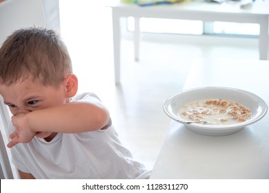 Little Boy Helps Dad Pour Milk Into Oatmeal. Quick Breakfast At Home