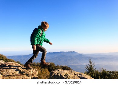 Little Boy Hiking In Scenic Mountains