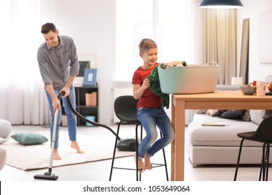 Little Boy And His Dad Cleaning Their House Together