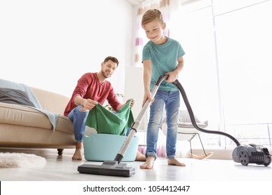 Little Boy And His Dad Cleaning Their House Together