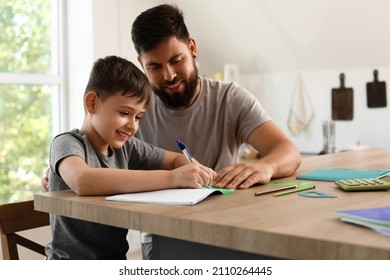 Little boy with his father doing lessons at home - Powered by Shutterstock