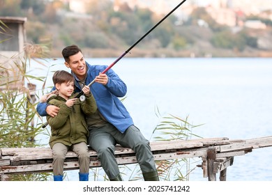 Little Boy And His Father Fishing On River