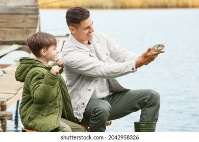 Little Boy And His Father Fishing On River