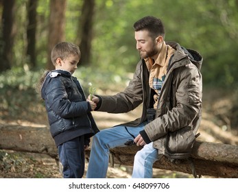 Little boy and his father are playing and learning about nature while hiking in the woods - Powered by Shutterstock