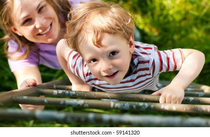 Little Boy And His Mother Climbing Up A Ladder From A Meadow, They Want To Reach Their Tree House (house Not To Be Seen)