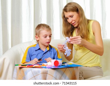 a little boy and his mother studying together at home