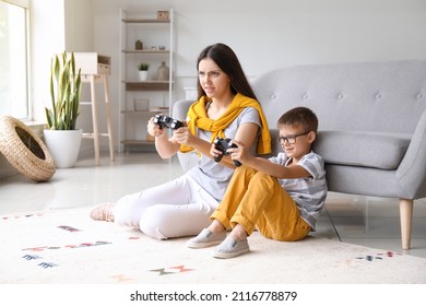 Little Boy With His Older Sister Playing Video Game At Home