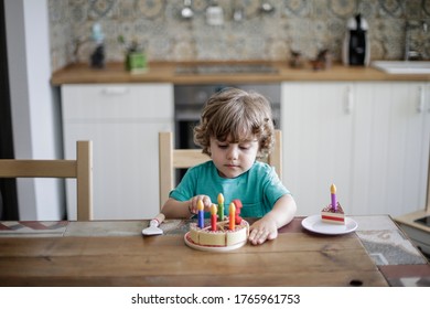 Little boy with his plastic cake - Shutterstock ID 1765961753