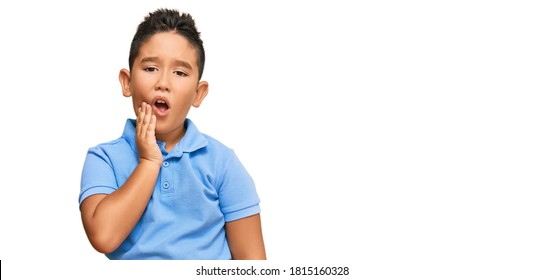 Little Boy Hispanic Kid Wearing Casual Clothes Touching Mouth With Hand With Painful Expression Because Of Toothache Or Dental Illness On Teeth. Dentist 