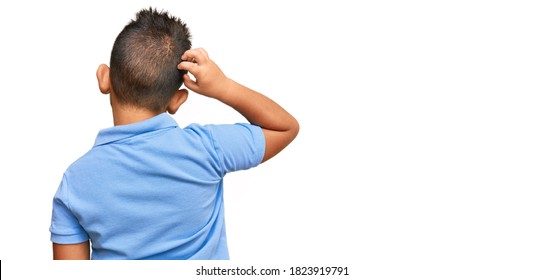 Little Boy Hispanic Kid Wearing Casual Clothes Backwards Thinking About Doubt With Hand On Head 