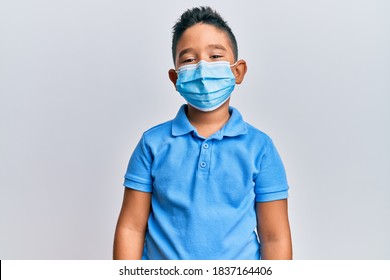 Little Boy Hispanic Kid Wearing Medical Mask With A Happy And Cool Smile On Face. Lucky Person. 