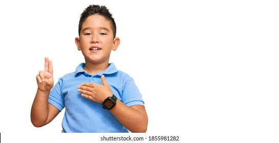 Little Boy Hispanic Kid Wearing Casual Clothes Smiling Swearing With Hand On Chest And Fingers Up, Making A Loyalty Promise Oath 