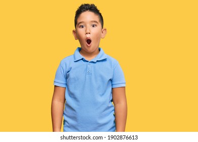 Little boy hispanic kid wearing casual clothes afraid and shocked with surprise and amazed expression, fear and excited face. 