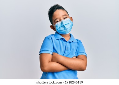 Little Boy Hispanic Kid Wearing Medical Mask Happy Face Smiling With Crossed Arms Looking At The Camera. Positive Person. 