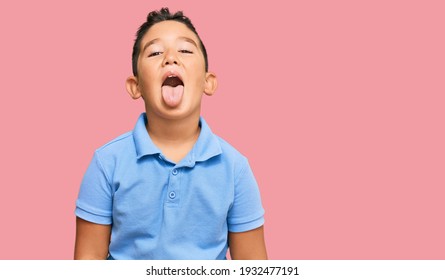 Little Boy Hispanic Kid Wearing Casual Clothes Sticking Tongue Out Happy With Funny Expression. Emotion Concept. 