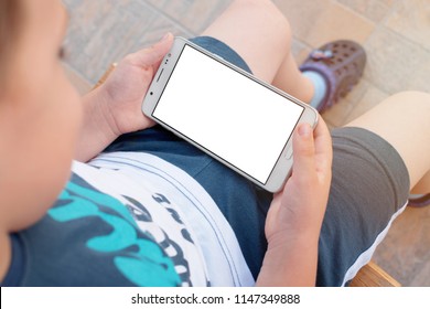 Little Boy Holding Phone In Horizontal Position With Isolated Screen, Top View. Kid Play Game, Surfing Online, Learning...etc. Mockup