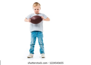 Little boy holding rugby ball isolated on white