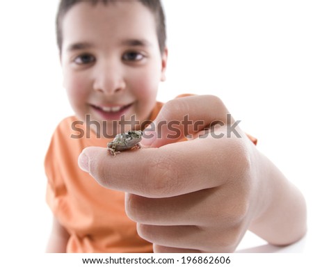 Little boy holding a small frog isolated on white background