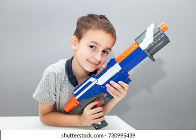 Little Boy Holding Toy Gun