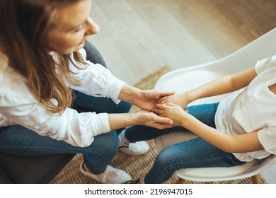 Little boy holds hands looks at aged therapist or pediatrician tell complaints to trustworthy medical worker at visit, trust relations with doctor, share disorder problems with psychologist concept - Powered by Shutterstock