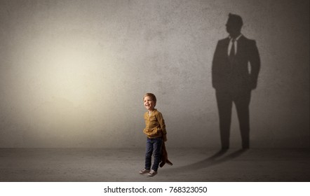 Little boy imagine that he will be businessman and illustrating his future in a big shadow