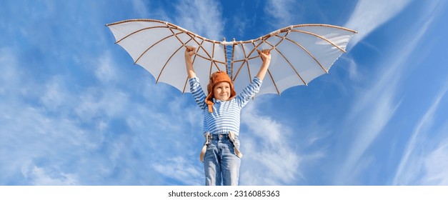 Little boy imagines flying.
Cheerful and happy child plays and dreams about airplanes with wings in the field against the blue sky. - Shutterstock ID 2316085363