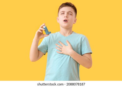 Little Boy With Inhaler Having Asthma Attack On Color Background