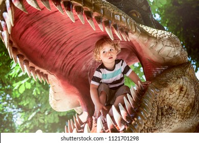 Little Boy Inside Of A Dinosaur's Mouth In Dino Park