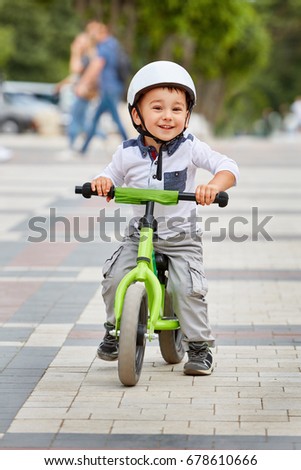 Similar – A funny boy riding his bicycle