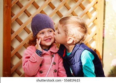 Little boy kissed for the first time adorable little girl. Love and romantic concept.