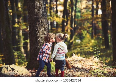 Little boy kisses girl on cheek. First kiss.
