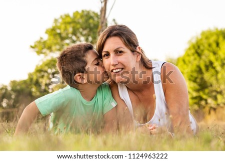 Image, Stock Photo Little boy kissing his mother on a field in summer