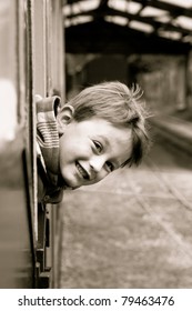 Little Boy Leaning Out Of A Train Window