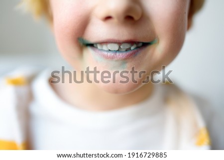 Little boy is learning carefully brush teeth. Child using liquid for disclosing plaque. Teaching children proper oral hygiene. Dental medicine and healthcare for kids.