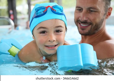 Little boy learning how to swim