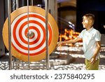 Little boy learns physics interactively on a model that shows physical phenomena while visiting a science museum. Concept of children