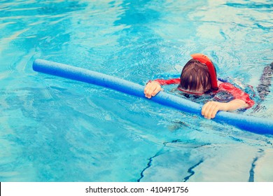 Little Boy Learns Swimming With Pool Noodle