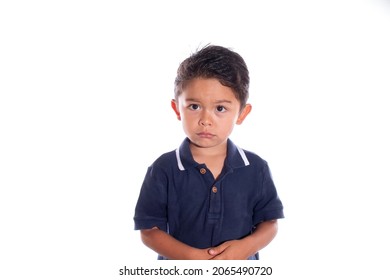 Little Boy With Look Of Sadness And Regret, Isolated On White Background. Latin Child Afraid Of Being Punished. Being Reprimanded.