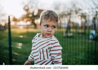 Little Boy Looking Away Outside In Park