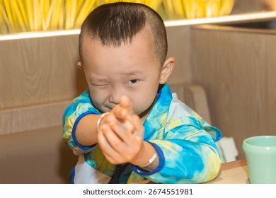 a little boy looking at camera
