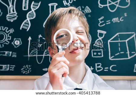 Similar – Happy kid looking at camera through magnifying glass