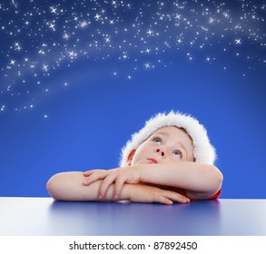 Little boy looking up to copy space, stars on night sky