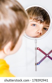 Little Boy Looking In A Vanity Mirror