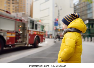 Little boy looks on fire engine. New York, USA. Little boy's dream concept