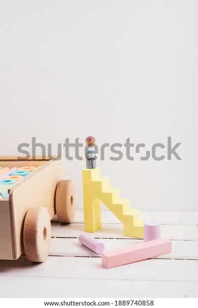Little boy made\
of wood. Children\'s toys made of natural material. Wooden\
construction kit in a large box-cars made of plywood. Colourful\
toys made of wood. Ecological\
material.