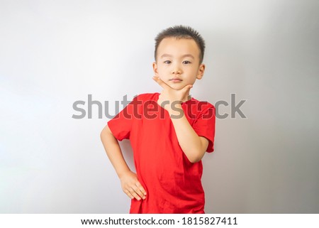 A little boy is making fun of in the white background