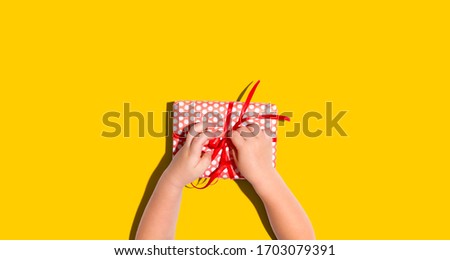 Similar – Image, Stock Photo Hand with a gift on pink background with copy space